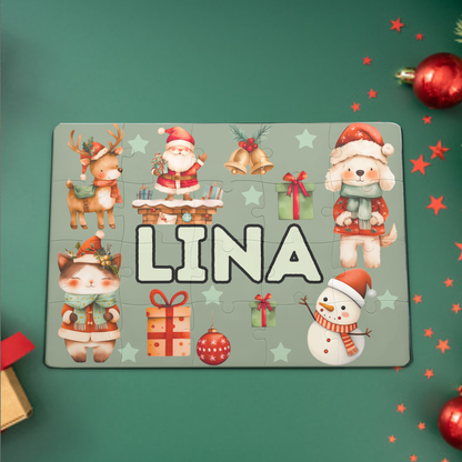 Personalizirana božična otroška sestavljanka z imenom , 20 kosov, z motivi Božička, snežaka, živali in daril, položena na zeleno podlago z okraski.